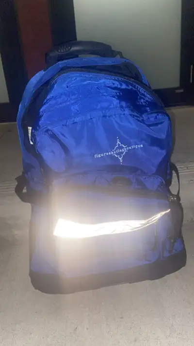 I'm selling a blue L.L. Bean figure skating backpack with a retractable handle and wheels, perfect f...