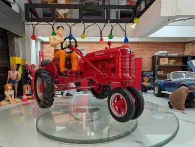 This is a used Farmall tractor collectable. This charming miniature Farmall tractor comes complete w...