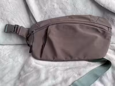 Selling a FWd belt bag in grey with green strap. Has lots of compartments to keep your things organi...