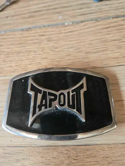 Own a piece of fighting history with this Tapout belt buckle, a true emblem of the mixed martial art...