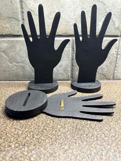 This set of black, wooden hand-shaped jewelry display stands is in used condition and perfect for sh...