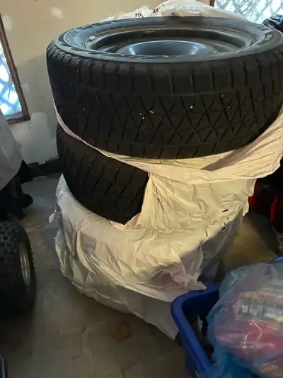 These are used Bridgestone Blizzak DM-V2 winter tires, size 275/55R20 117, ready to tackle the snowy...