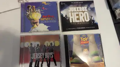 For sale is a collection of four musical CDs, including titles such as Monty Python's Spamalot, Juke...
