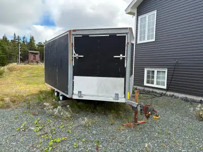 One double axle v-nose enclosed trailer. 16’ long. Drive in/ drive out.