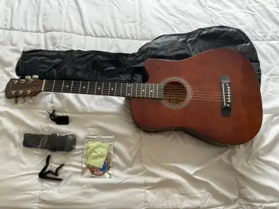 Bought on Amazon a few months back. Great condition. Sounds good for cheap guitar. Unused strap, cas...