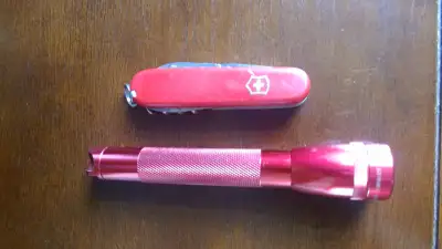 Victorinox spartan is a 91mm knife in good condition and complete. Maglite flashlight is about 15cm...