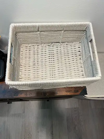 Rectangular white woven rope storage basket with handles. Good size for organizing general household...