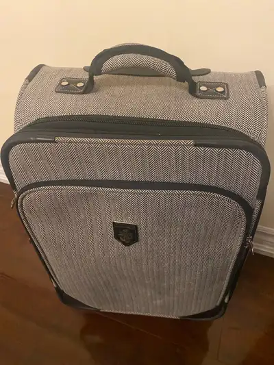 I am selling a Heys grey patterned carry-on suitcase, perfect for your travel needs. This compact an...