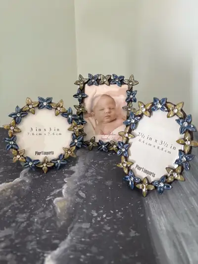 Set of three Pier 1 Imports picture frames, each adorned with blue and gold flower accents and spark...