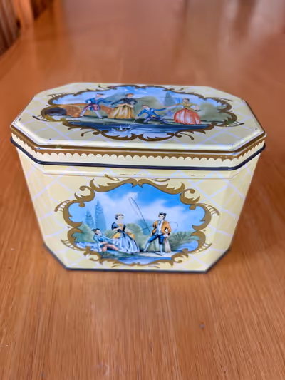 Here is a fantastic yellow & white plaid biscuit tin featuring lively scenes of people fishing. Made...