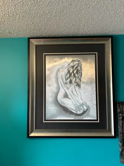 This captivating framed art piece features a nude woman in a seated position, rendered in striking m...