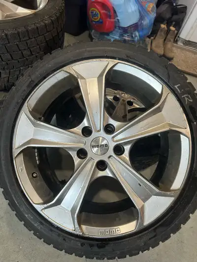 Set of four (4) Momo 18-inch rims paired with Blizzak run-flat tires, sized at 245/40R18. The rims a...