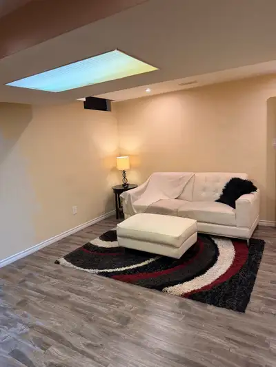 This cozy and clean basement apartment features a modern living space with durable laminate flooring...