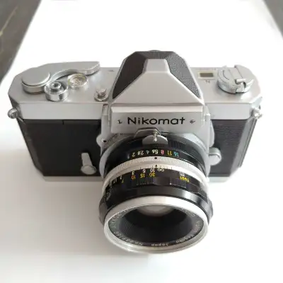 Capture timeless moments with this classic Nikon Nikomat FTN 35mm film camera, paired with a versati...