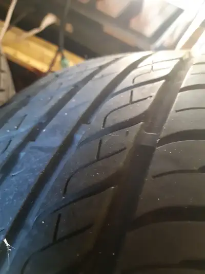set of 4 all-season tires size 205/65 R15, come with rims, off an early 2000s Pontiac GrandAm