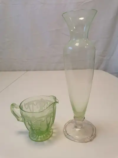 Pair of vintage green glass pieces featuring a Depression Glass creamer and bud vase. The creamer is...