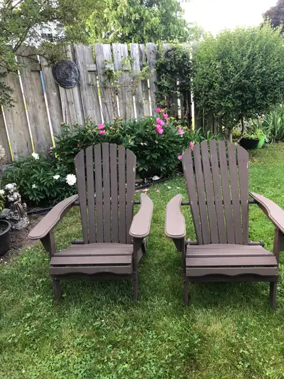 Relax in style with these two foldable, brown Adirondack chairs, perfect for any backyard or patio s...