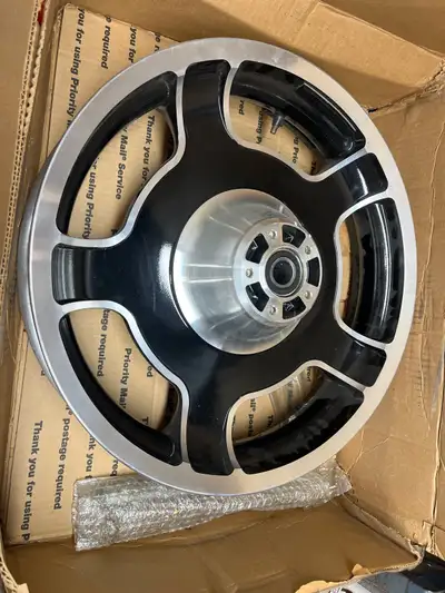 This high-quality, used Harley-Davidson motorcycle rear wheel features a stylish black and machined...