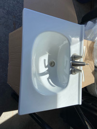 Porcelain sink and brushed nickel Moen Taps for sale 