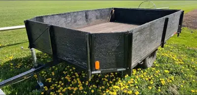 Well built 10 foot long by 7 foot wide flat deck utility trailer with 20 inch high removable sides a...