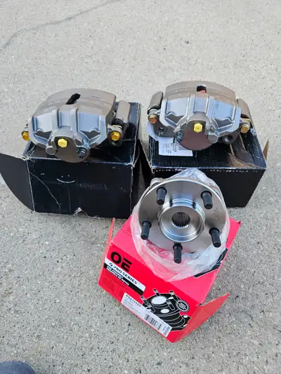 Set of brand new brake calibers with brackets never used and a brand new hub bearing they all fit on...