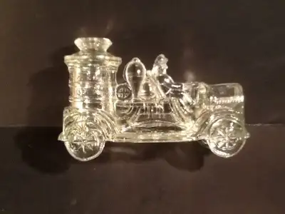 Collection of seven vintage glass candy containers in the shape of old time fire engines and cars. O...