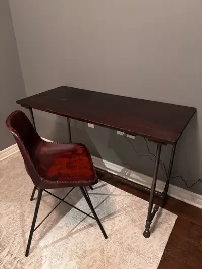 Dark brown wooden top. Metal pipe legs. Simple design. Great for home office or small space. Height...