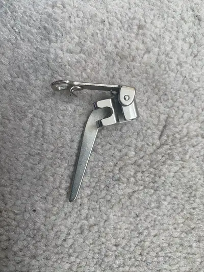 This is a used sewing machine presser foot, perfect for various sewing projects. It's in good condit...