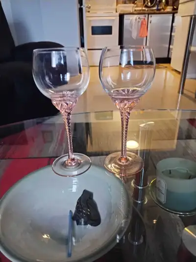 These vintage crystal wine glasses are in used, but good condition, showcasing their delicate pink t...