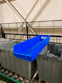 Used stacking plastic bins and industrial shelving for sale.