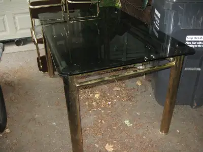 Large smoked glass table with brass legs, View more