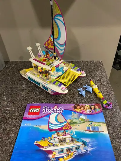 Take a luxury cruise on the LEGO® Friends Sunshine Catamaran, with a sun deck, pool, bridge, slide,...