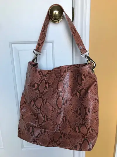 New, never used tote bag with sturdy handle. Burnt orange/brown colour. One internal zip pocket and...