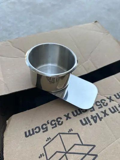 Set of ten poker table cup holders. One is missing the metal flap that slides under the table armres...