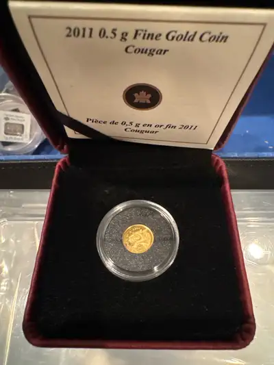Selling a 2011 0.5g Fine Gold Coin featuring a Cougar design. It comes in its original box. With cer...
