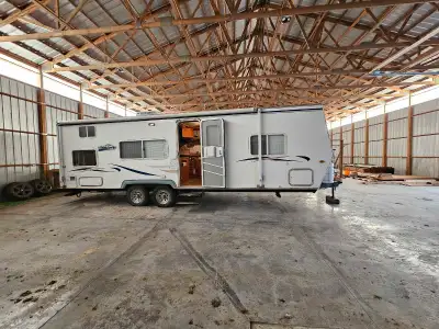 Bumper pull. Hard wall. Bunk beds in back. Queen bed in front. Table converts to bed and couch conve...