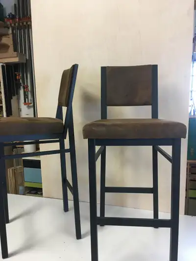 2 high bar stools. Heavy black metal, faux suede seats., View more
