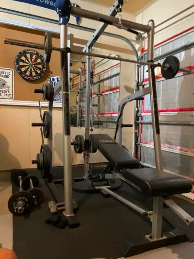 All in one with olympic bar and several extra bars and weights., View more