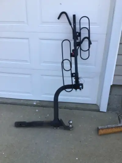 Two place bike rack c/w hitch extension & ball. Never been used
