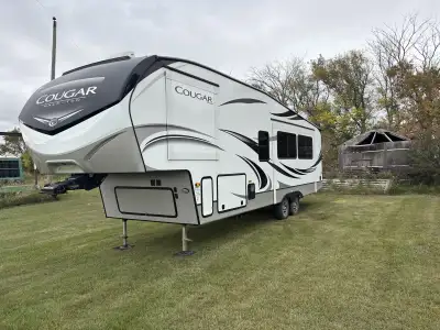 We are selling our like new 2020 5th Wheel Travel Trailer. This adult floor plan is hard to find, ve...