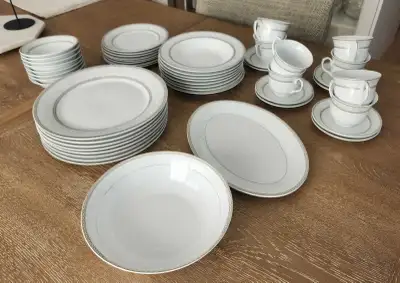 This elegant Mikasa fine china dinnerware set features a timeless white design with subtle grey deta...