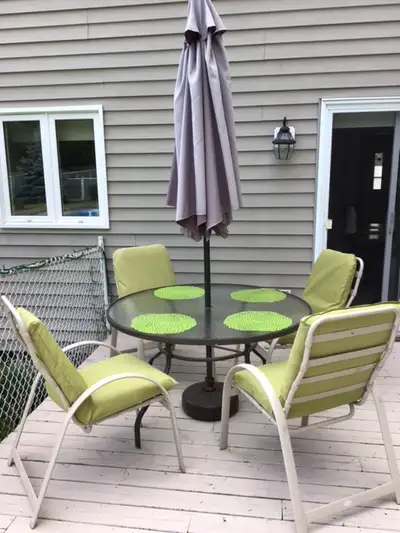 Round Glass Table 50 Inches in diameter Umbrella Bse for Unbrella 4 Chairs 4 cushions with indoor/ou...