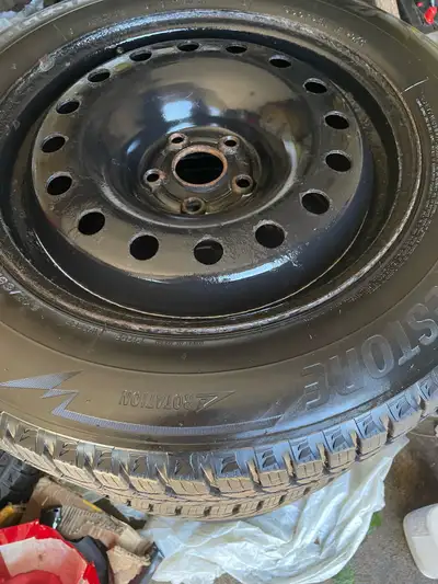 Set of four Excellent Bridgestone Blizzak winter tires/rims. The tire number is 215-65-17. They are...