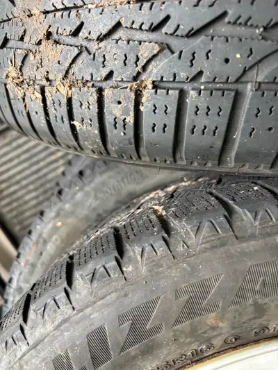 4 Winter tires on rims with hub caps Came off Mazda 3 $150 for all 4