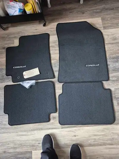 These are a set of genuine OEM Toyota Corolla floor mats, offering durable protection for your vehic...