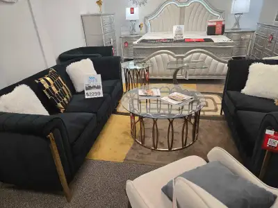 This elegant used black velvet sofa set includes a three-seater sofa, a loveseat, and an ottoman, pe...