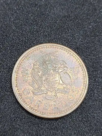 I am selling this vintage 1987 Barbados one cent coin, which features the national coat of arms on t...