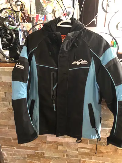 This is an HMK women's black and blue snowmobile or motorcycle jacket in size XS. This jacket is in...