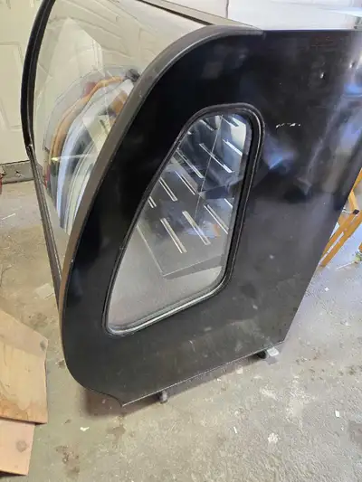 commercial refrigerator display case, designed to keep food fresh and appealing. This unit is in goo...