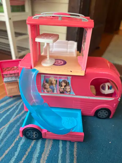 This Barbie Glam Getaway Camper expands with a slide, pool and accessories for the ultimate camping...